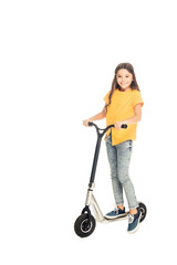 adorable happy child riding scooter and smiling at camera isolated on white