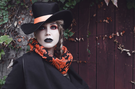 Young pale taned woman with dark make up