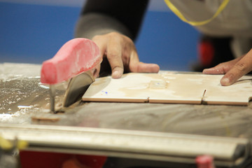 Man to cut tile by chainsaw for To lay out textiles by industrial man for interior decoration