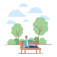 young man with beard seated in chair on the park