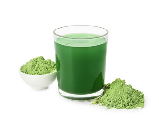 Glass of fresh wheat grass juice and powder on white background