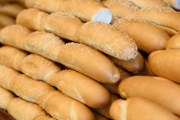 Breads and baked goods close-up. Bakery, baguette, bun, bread roll background.