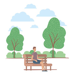 young man seated in chair on the park
