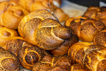Breads and baked goods close-up. Fresh challah bread for shabbat. Bakery bread bun background.