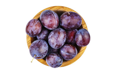 ripe plums in a plate isolated