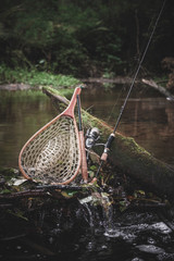 Fishing gear on the background of a picturesque forest river.