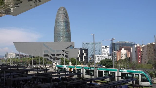 Barcelona urban landscape with the tram and Central Business Area buildings in the background, Barcelona, Spain