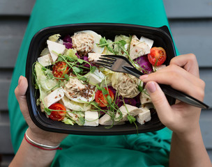 Woman eating healthy food at lunch time