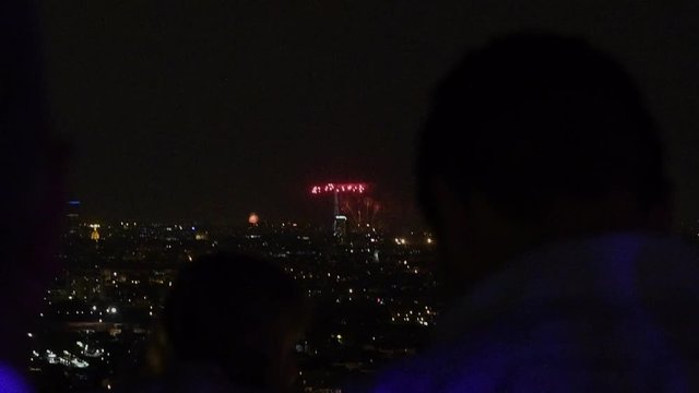 skyscraper terrace above Paris admiring fireworks