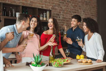Multiracial friends enjoying small party at home