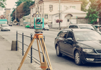 Surveyor device electronic total station on the street. Measurement of the relief.