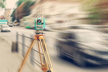 Surveyor device electronic total station on the street. Measurement of the relief.