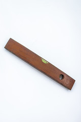Old vintage wood ruler level meter on the white background 