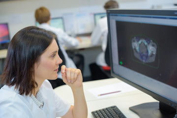 Fototapeta na wymiar Medical worker looking at image on computer screen