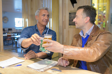 two men toasting a drink