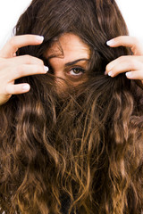 Beautiful woman removing her hair from her face on white background