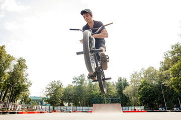 Boy jumping with bmx in skate park