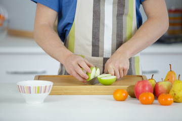 man cutting apples