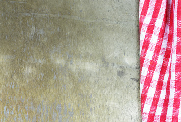 Fototapeta premium Red checkered napkin on rusty background, copy space