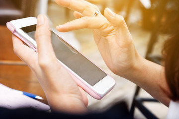 Close up of Young woman using smart phone in cafe