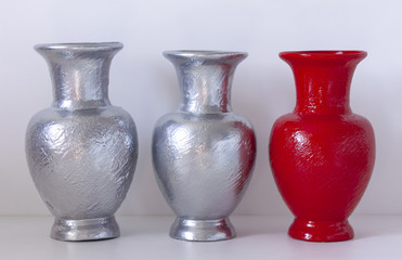Home decor - colored vases on the table against white wall