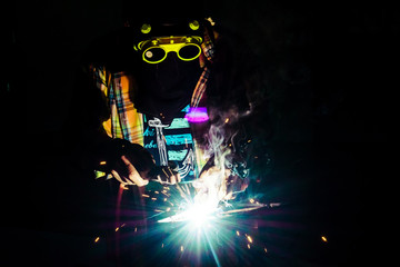 Welding zone elements of steel construction with the use of the method MAG cored wire,Skilled welder wearing