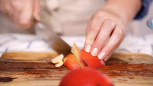 Step by step. Slicing red apples for filling to make empanadas