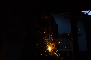 Welding zone elements of steel construction with the use of the method MAG cored wire,Skilled welder wearing