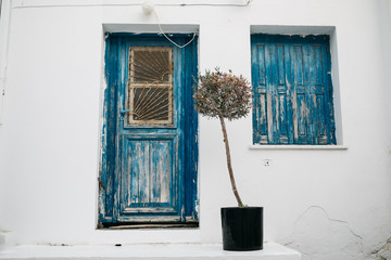 traditional greek blue doors and window with blue shutters