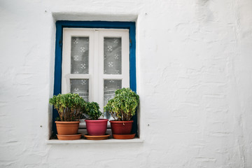 Fototapeta na wymiar Window with pots on Paros, Greece