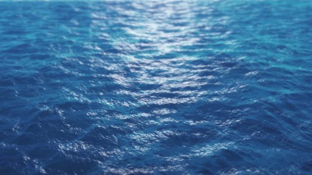 Over ocean water surface. 4K seamless loop blue sea and sun light