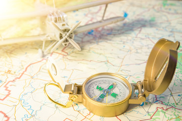 travel concept. vintage compass on a map and plane in the background. Tourism, recreation. air flight.