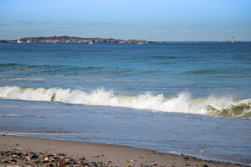 Nantasket Beach in Hull MA with Boston Light in the distance