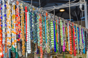 women's beads and necklace hanging in the exhibition
