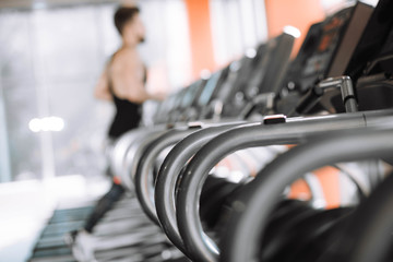 Obraz na płótnie Canvas man runs on a treadmill in the gym