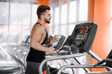 Fototapeta na wymiar man runs on a treadmill in the gym