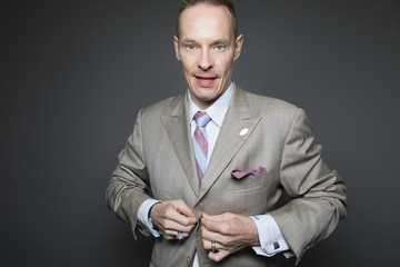 Businessman Closing Jacket