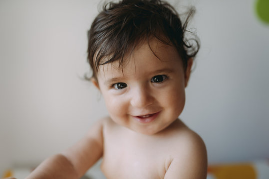 Portrait of smiling baby girl at home