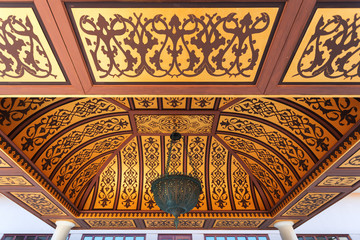 A beautiful gazebo in oriental style with soft sofas and tables in the building courtyard, Turkish ornaments