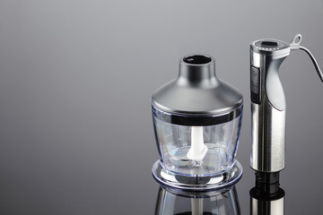 Blender with accessory on the grey mirror background