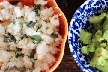 Fillings in colorful bowls, avocado and feta cheese, healthy summer foods