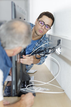 Ethernet Cable Being Plugged Into A Wall Socket