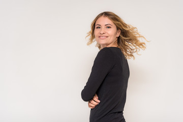 Obraz premium Portrait of a beautiful blonde girl on a white background in a dress.