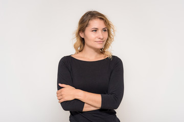 Fototapeta premium Portrait of a beautiful blonde girl on a white background in a dress.