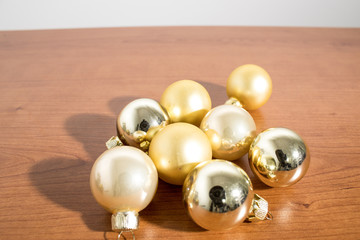 Christmas decorations, detailed gold christmas balls on a wood table
