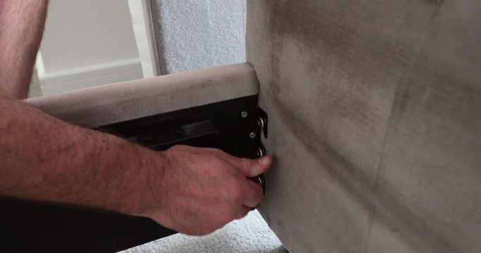 Mature Man Using Hex Wrench for Bed Frame
