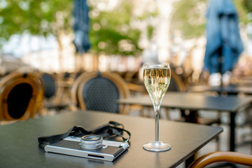 Champagne with photocamera at the bar outdoors