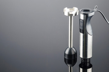Blender with accessory on the grey mirror background