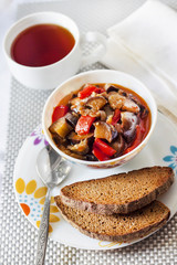 Vegetable sauté with eggplant, red pepper and tomatoes, and toasted rye bread