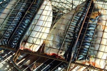 Grilled fish mackerel. Skewers of fish. Close-up. Background.